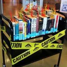 books with yellow warning tap around them